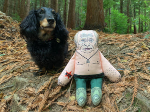 Vladimir Putin dog toy in woods with dog